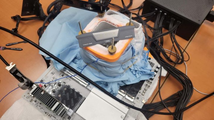 A setup featuring a GIGABYTE motherboard with an AMD Ryzen CPU under liquid nitrogen cooling for overclocking, with visible signs of frost and a 'Computex 2026' labeled DDR5 RAM module.